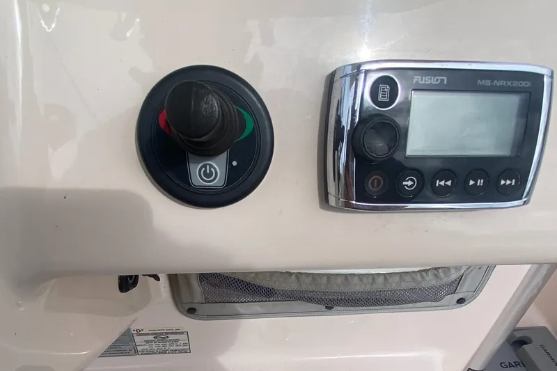 Slide: The Image of Control panel of a 2014 Grady-White Canyon 306 boat with joystick and Fusion stereo. - 21