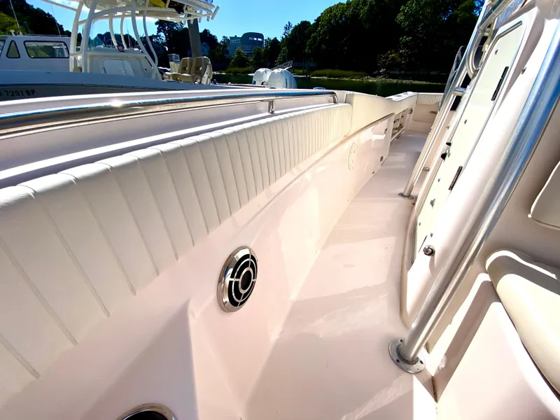 Slide: The Image of 2014 Grady-White Canyon 306 boat deck, featuring sleek design and stainless steel fixtures. - 24