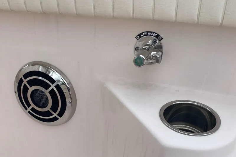 Slide: The Image of 2014 Grady-White Canyon 306 boat detail with raw water outlet and speaker. - 26