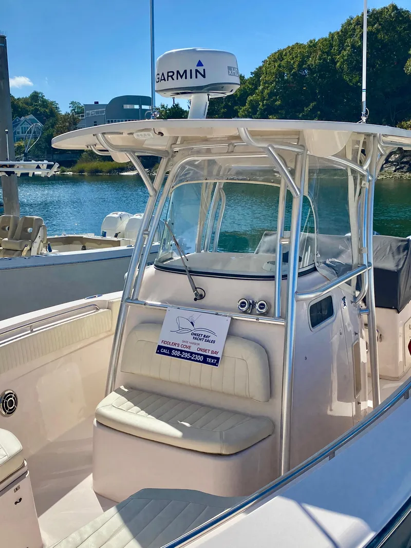 Slide: The Image of 2014 Grady-White Canyon 306 boat with Garmin radar, docked in a sunny marina. - 3