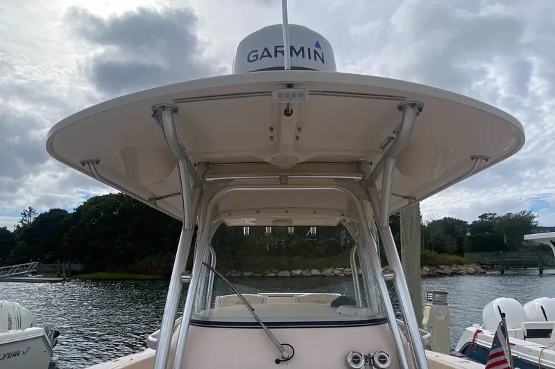 Slide: The Image of 2014 Grady-White Canyon 306 boat with Garmin radar, docked by a scenic waterfront. - 4