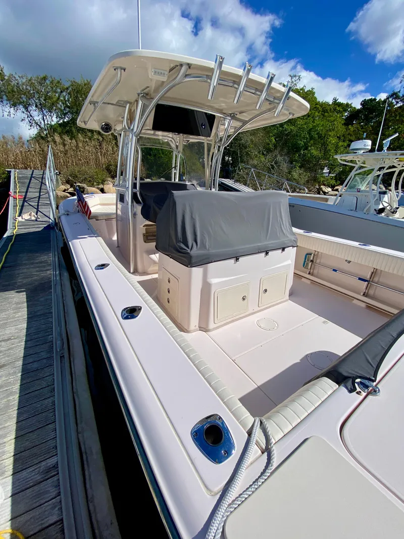 Slide: The Image of 2014 Grady-White Canyon 306 boat docked, featuring spacious deck and covered console. - 7