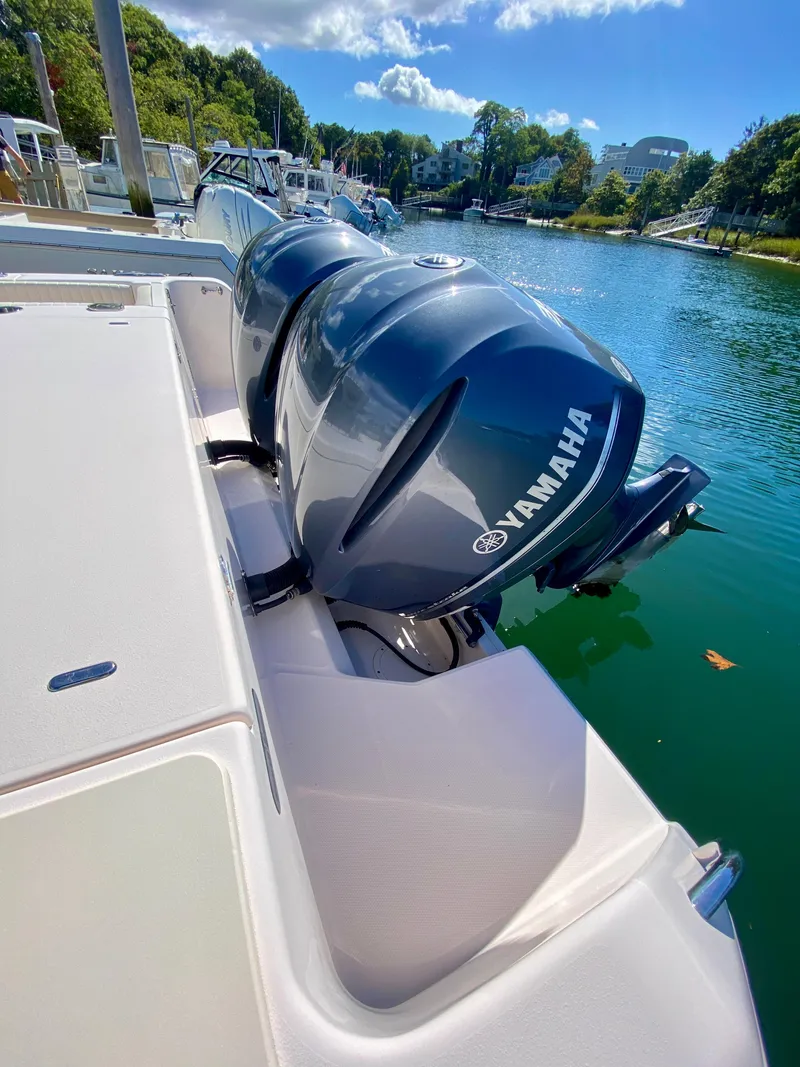 Slide: The Image of 2014 Grady-White Canyon 306 with Yamaha outboard engines docked by a scenic waterfront. - 8