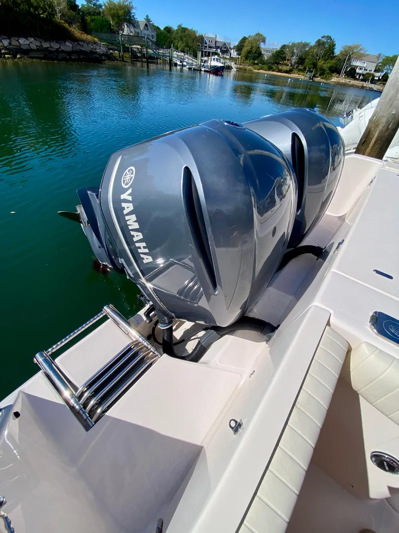 Slide: The Image of 2014 Grady-White Canyon 306 with dual Yamaha outboard motors on a calm waterway. - 9