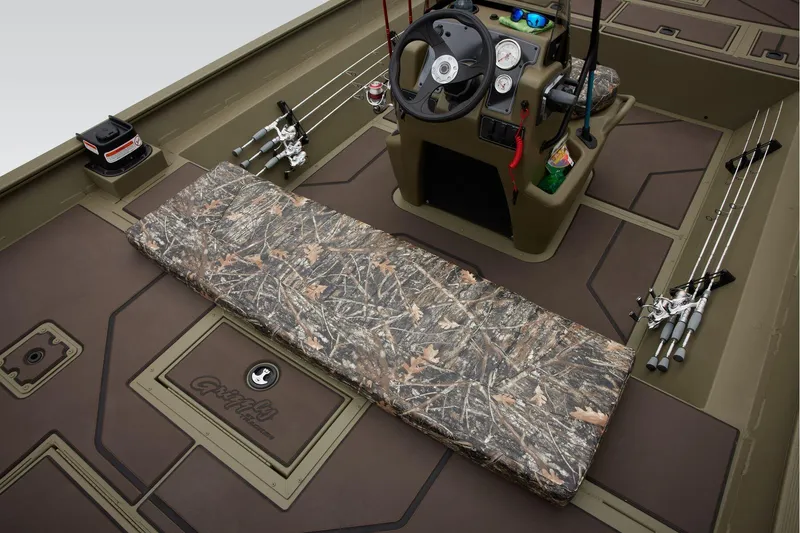 Slide: The Image of Manufacturer Provided Image: 2026 Tracker Grizzly 2072 CC boat interior with camo seating and fishing rods. - 27