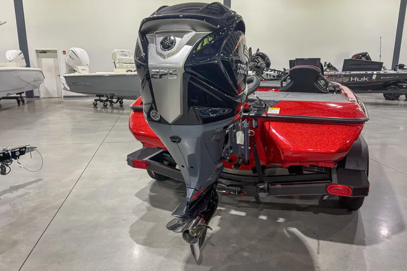 Slide: The Image of Red Skeeter ZXR19 boat with powerful outboard motor, showcased in a showroom, 2026 model. - 10