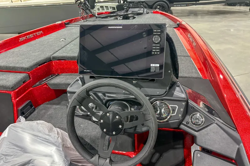 Slide: The Image of Red 2026 Skeeter ZXR19 boat interior with steering wheel and Humminbird Xplore 12 display. - 11