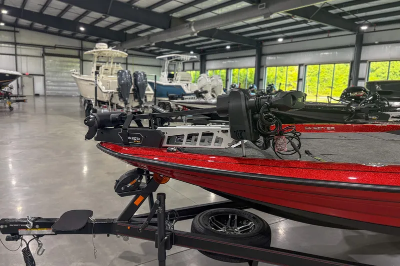 Slide: The Image of Red 2026 Skeeter ZXR19 boat in showroom, featuring Minn Kota motor. - 2