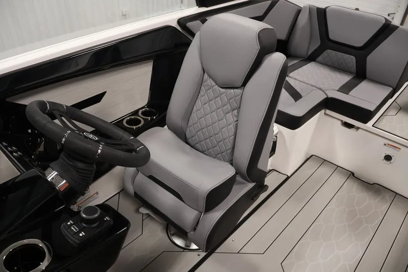 Slide: The Image of Interior of 2026 Yamaha Boats 222XE, featuring sleek steering and modern seating design. - 25