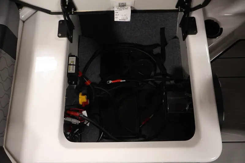 Slide: The Image of Storage compartment of 2026 Yamaha Boats 222XE, featuring wiring and components. - 29