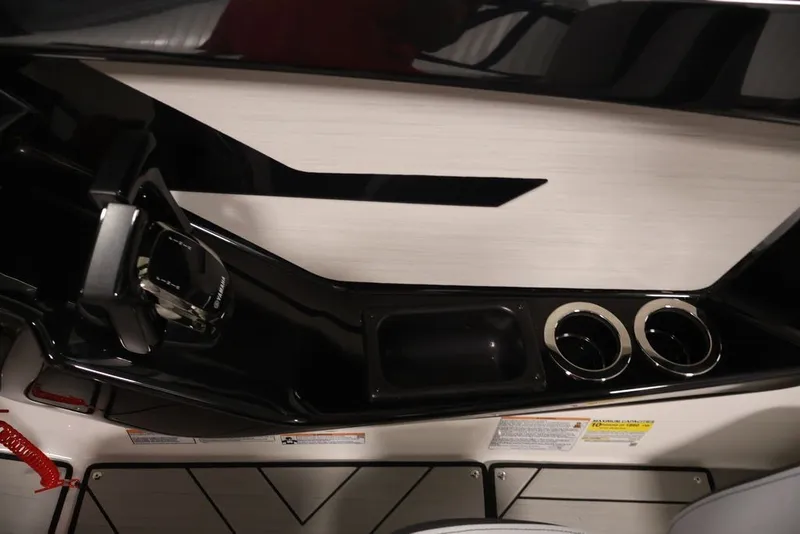 Slide: The Image of Interior of 2026 Yamaha Boats 222XE, featuring sleek controls and dual cup holders. - 23