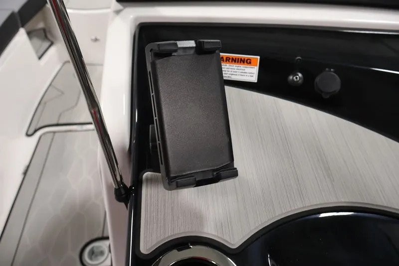 Slide: The Image of Yamaha Boats 2026 222XE dashboard with phone holder and warning label. - 28