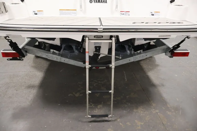 Slide: The Image of Rear view of 2026 Yamaha Boats 222XE with ladder and trailer attachment. - 38