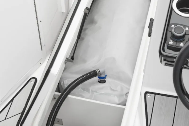 Slide: The Image of 2026 Yamaha Boats 222XE interior storage compartment with hose and control panel. - 42