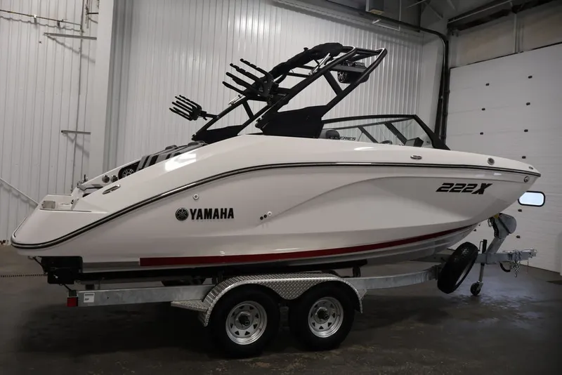 Slide: The Image of 2026 Yamaha Boats 222XE in a garage, side view on a trailer. - 2