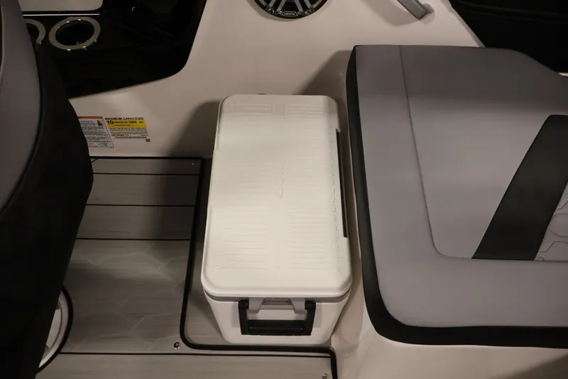 Slide: The Image of Interior of 2026 Yamaha Boats 222XE featuring seating and a white cooler. - 41