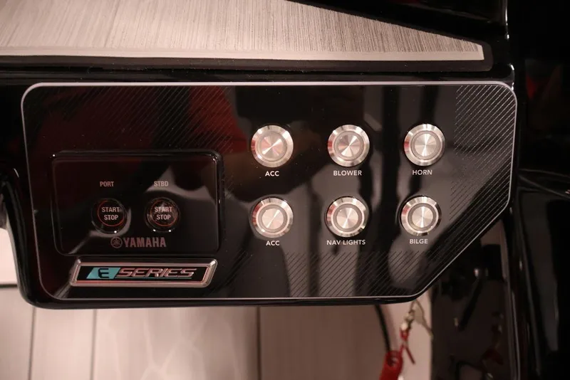 Slide: The Image of Control panel of 2026 Yamaha Boats 222XE with labeled buttons and switches. - 22