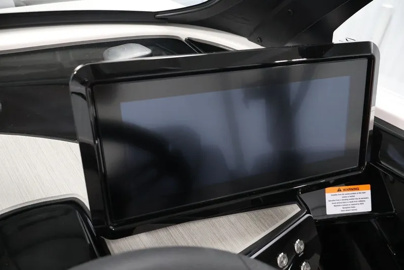 Slide: The Image of Touchscreen display on 2026 Yamaha Boats 222XE dashboard, featuring sleek design and warning label. - 24