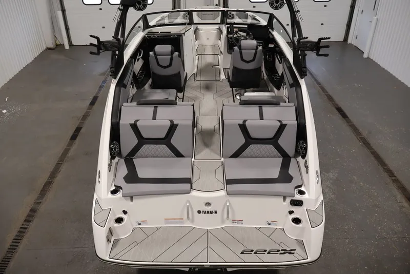 Slide: The Image of 2026 Yamaha Boats 222XE interior, showcasing sleek seating and modern design in a spacious layout. - 6
