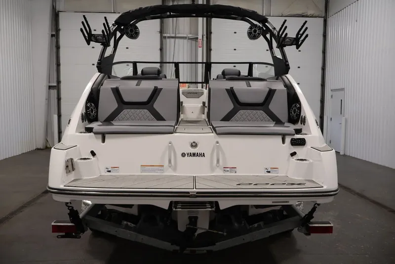 Slide: The Image of 2026 Yamaha Boats 222XE rear view in a garage setting. - 20