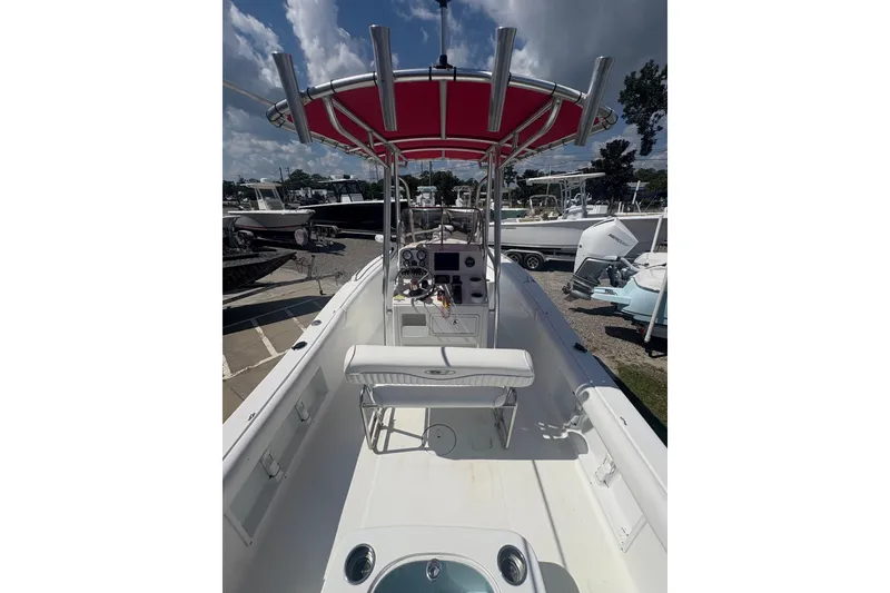 Slide: The Image of 2010 Sea Hunt Triton 202 boat with red canopy and spacious deck. - 12