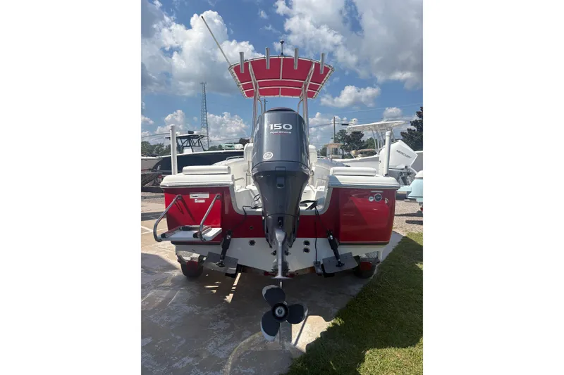 Slide: The Image of 2010 Sea Hunt Triton 202 boat with red hull and 150 horsepower outboard motor. - 3