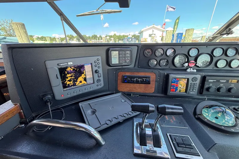 Slide: The Image of Cockpit of 1989 Sea Ray 400 Express Cruiser with navigation equipment and controls. - 13