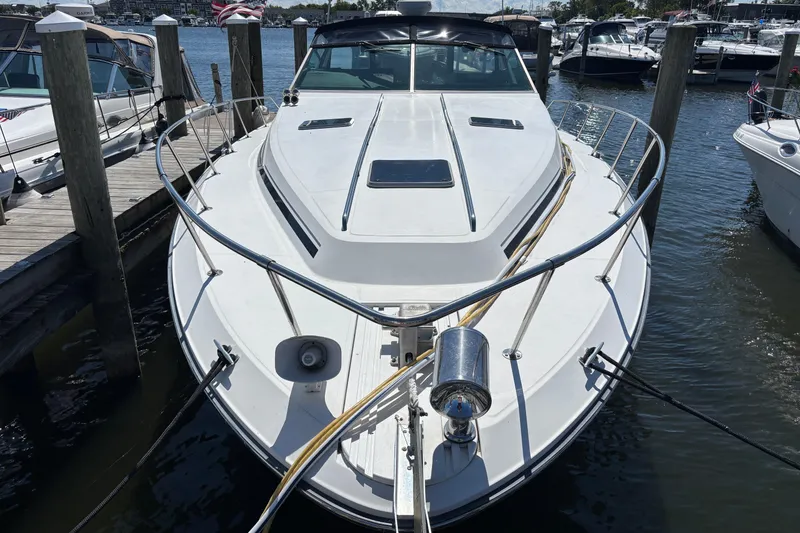 Slide: The Image of 1989 Sea Ray 400 Express Cruiser docked at marina, front view. - 2