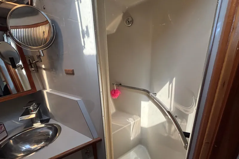 Slide: The Image of Bathroom interior of 1989 Sea Ray 400 Express Cruiser with shower and sink. - 22