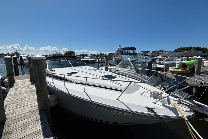Slide: The Image of 1989 Sea Ray 400 Express Cruiser docked at marina under clear blue sky. - 3