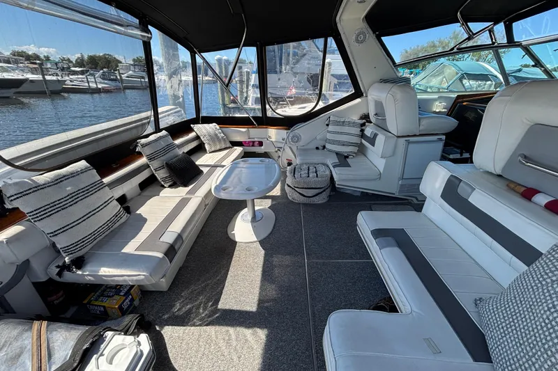 Slide: The Image of Interior of 1989 Sea Ray 400 Express Cruiser with plush seating and waterfront view. - 6