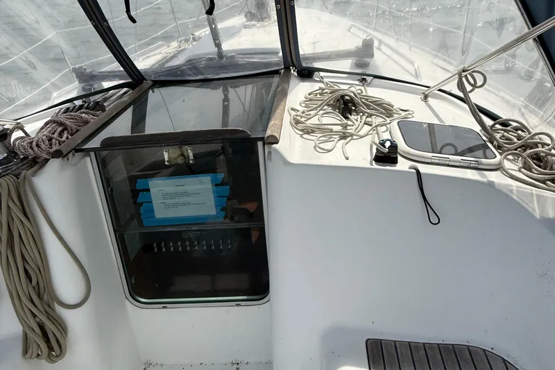 Slide: The Image of Cockpit view of 2003 Beneteau Oceanis Clipper 361 with ropes and navigation equipment. - 13