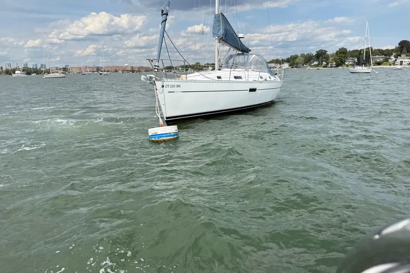 Slide: The Image of Sailboat Beneteau Oceanis Clipper 361, 2003 model, anchored on a sunny day. - 15