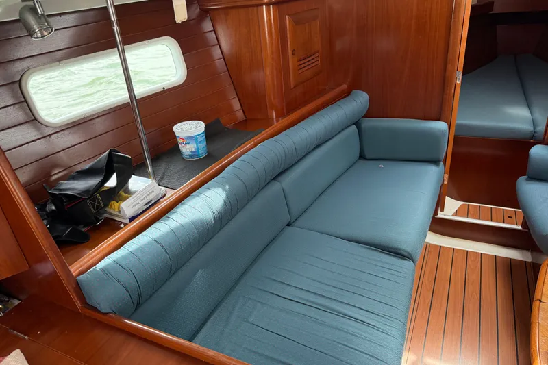 Slide: The Image of Interior of 2003 Beneteau Oceanis Clipper 361 with blue seating and wooden finish. - 17