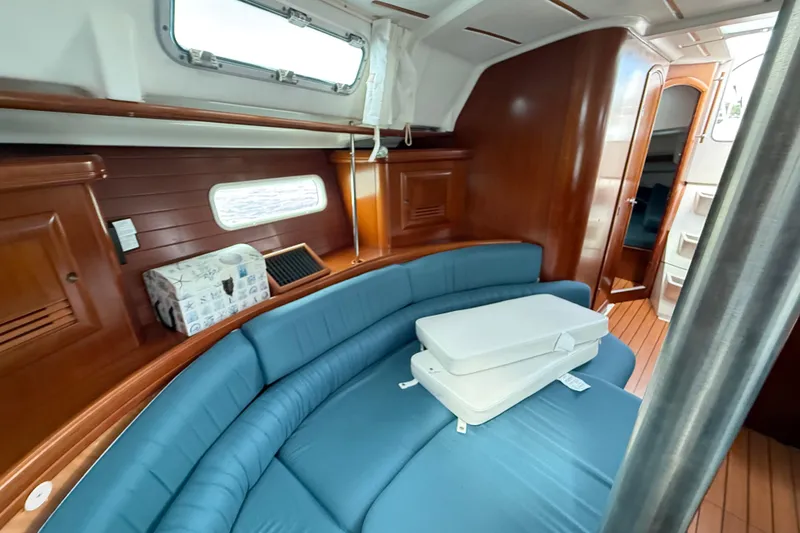 Slide: The Image of Interior of 2003 Beneteau Oceanis Clipper 361 with blue seating and wooden finishes. - 20