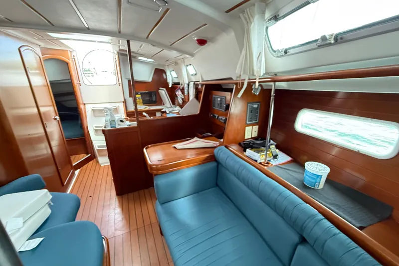 Slide: The Image of Interior of 2003 Beneteau Oceanis Clipper 361 sailboat with wood finish and blue seating. - 22