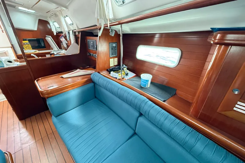Slide: The Image of Interior of 2003 Beneteau Oceanis Clipper 361 yacht with blue seating and wooden finishes. - 23