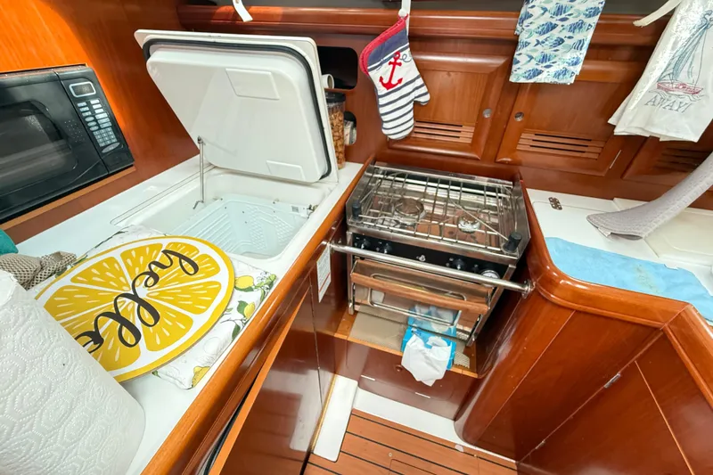 Slide: The Image of Galley of 2003 Beneteau Oceanis Clipper 361 with stove, microwave, and storage. - 30