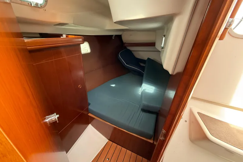 Slide: The Image of 2003 Beneteau Oceanis Clipper 361 cabin interior with wooden finish and cozy sleeping area. - 31