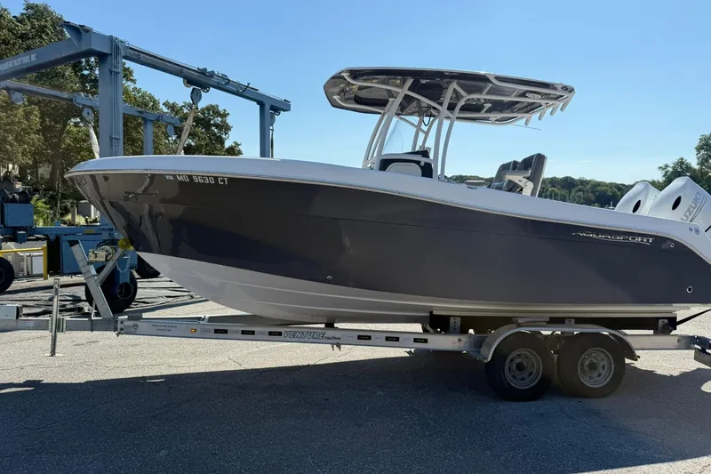 The Image of 2023 Aquasport 2500 Center Console boat on trailer, ready for transport. - 0