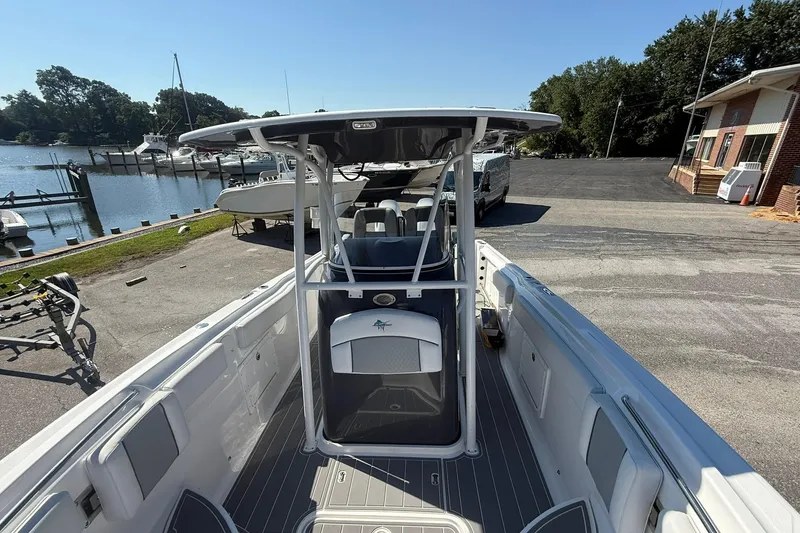 Slide: The Image of 2023 Aquasport 2500 Center Console boat docked near waterfront. - 14