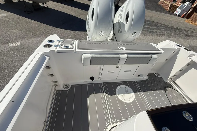 Slide: The Image of 2023 Aquasport 2500 Center Console boat with dual engines and spacious deck layout. - 21