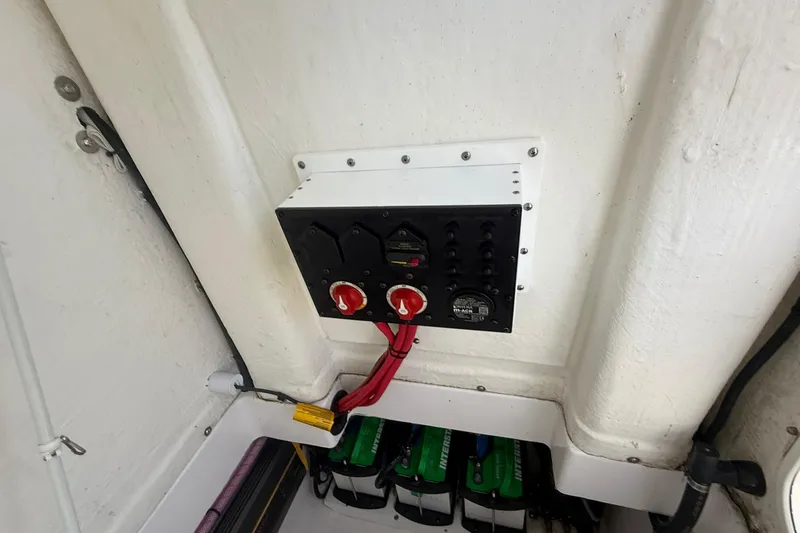 Slide: The Image of 2023 Aquasport 2500 Center Console electrical panel with switches and wiring. - 24