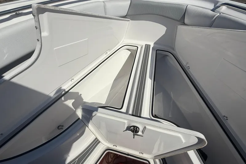 Slide: The Image of 2023 Aquasport 2500 Center Console boat storage compartments open. - 26