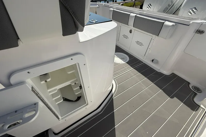 Slide: The Image of 2023 Aquasport 2500 Center Console boat interior with storage compartments and seating. - 27