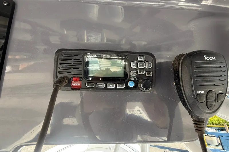 Slide: The Image of 2023 Aquasport 2500 Center Console with Icom marine radio and microphone. - 31