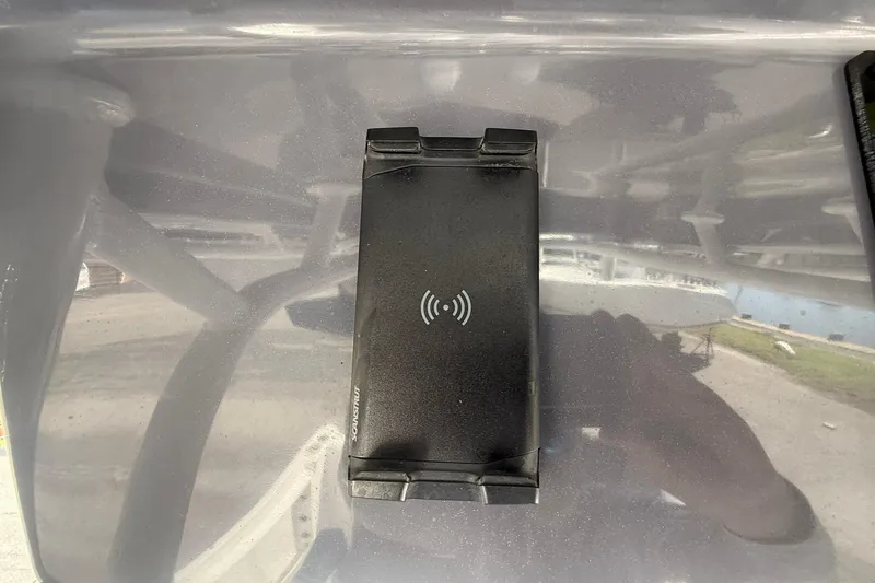 Slide: The Image of Wireless charging pad on 2023 Aquasport 2500 Center Console boat dashboard. - 32