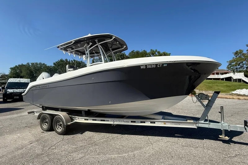 Slide: The Image of 2023 Aquasport 2500 Center Console boat on trailer, parked outdoors. - 5