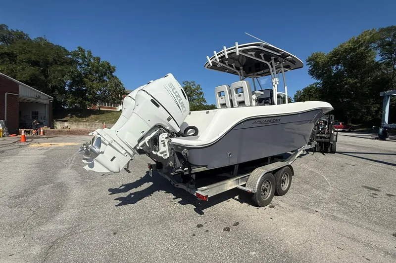 Slide: The Image of 2023 Aquasport 2500 Center Console boat on trailer, featuring Suzuki outboard motor. - 6