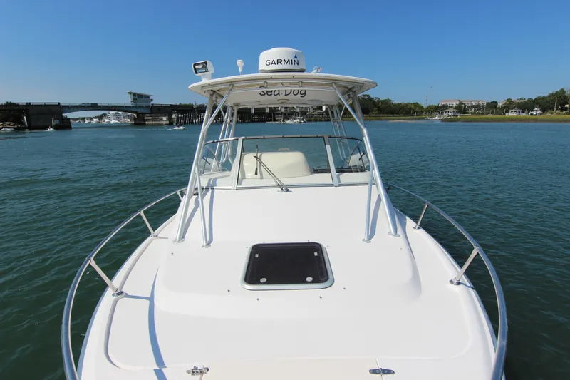 Slide: The Image of 2001 Grady-White Express 265 boat on water, bridge and shoreline in background. - 10